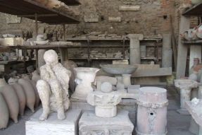 This picture taken on Nov. 9, 2012 through the protective glass of the Orto dei fuggiaschi (The garden of the Fugitives) shows the 13 bodies of victims who were buried by the ashes as they attempted to flee Pompeii during the 79 AD eruption of the Vesuvius volcano.